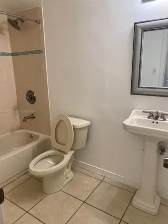 a view of a room with white tiles