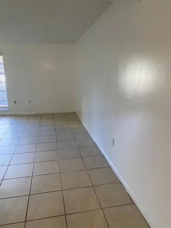 a view of an empty room and a window