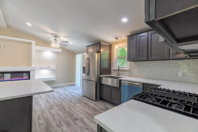 a kitchen with refrigerator and cabinets