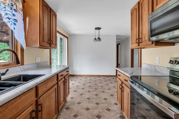 a kitchen with stainless steel appliances a sink stove and microwave