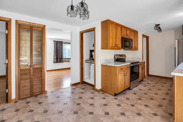 a kitchen with stainless steel appliances a refrigerator and a stove