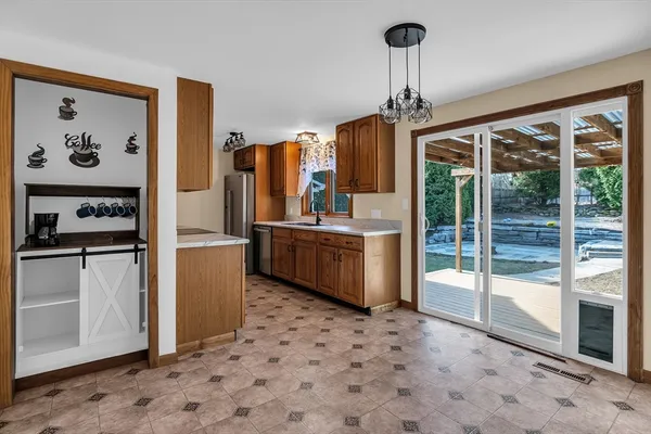 a kitchen with stainless steel appliances a stove a refrigerator and a sink