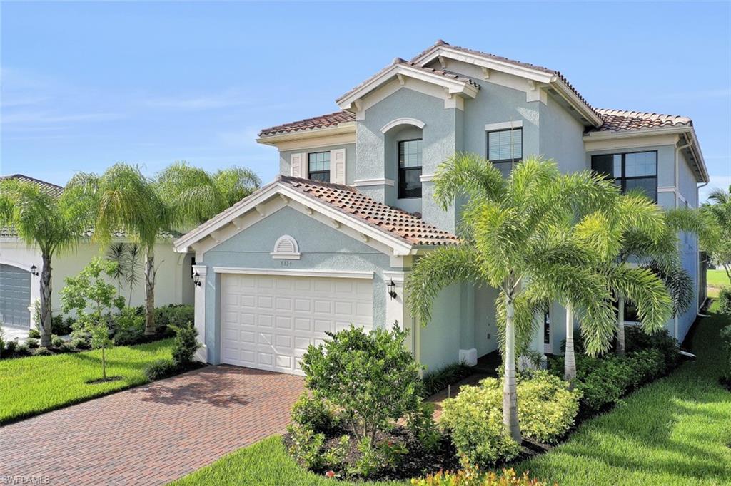 4334 Aurora Street Naples, FL 34119 - Photo 1 of 31 a front view of a house with a yard and potted plants