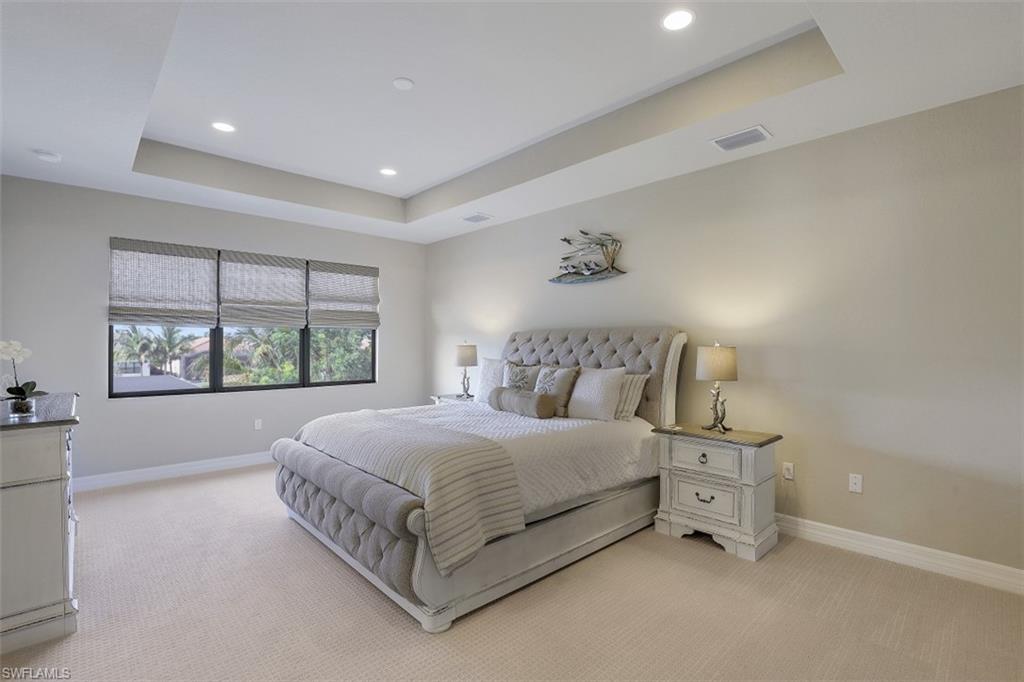 4334 Aurora Street Naples, FL 34119 - Photo 13 of 31 a bedroom with a bed and a window