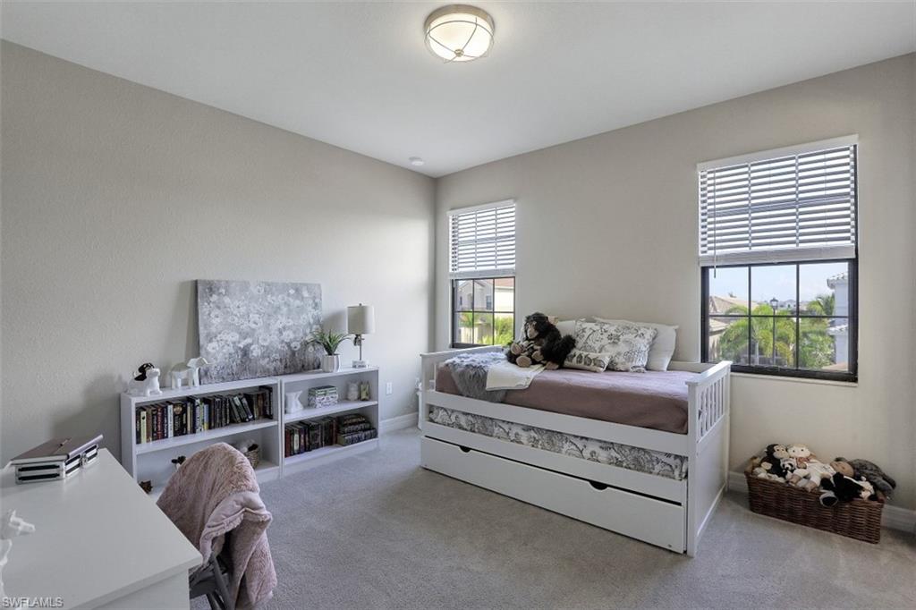 4334 Aurora Street Naples, FL 34119 - Photo 19 of 31 a bedroom with furniture and a window