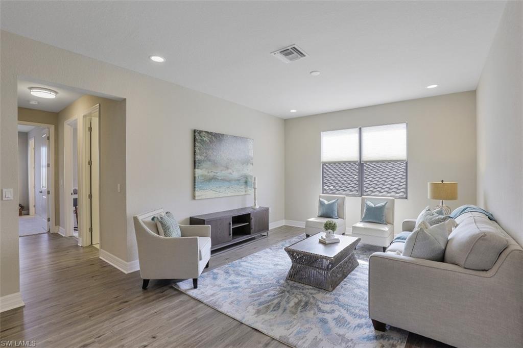 4334 Aurora Street Naples, FL 34119 - Photo 20 of 31 a living room with furniture and a wooden floor