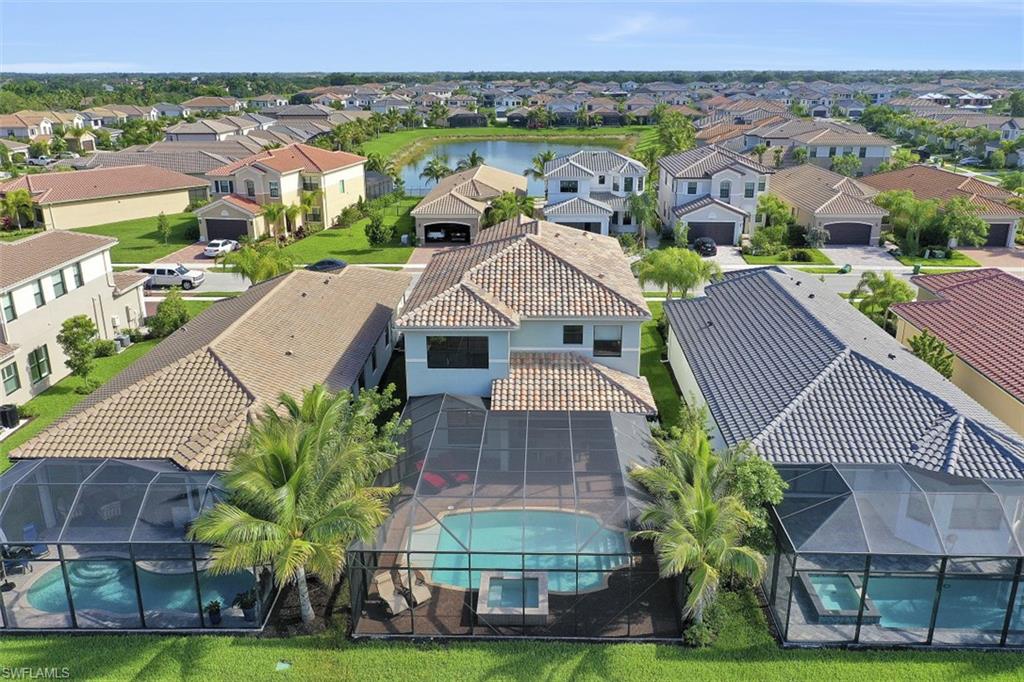 4334 Aurora Street Naples, FL 34119 - Photo 2 of 31 an aerial view of multiple houses with a yard