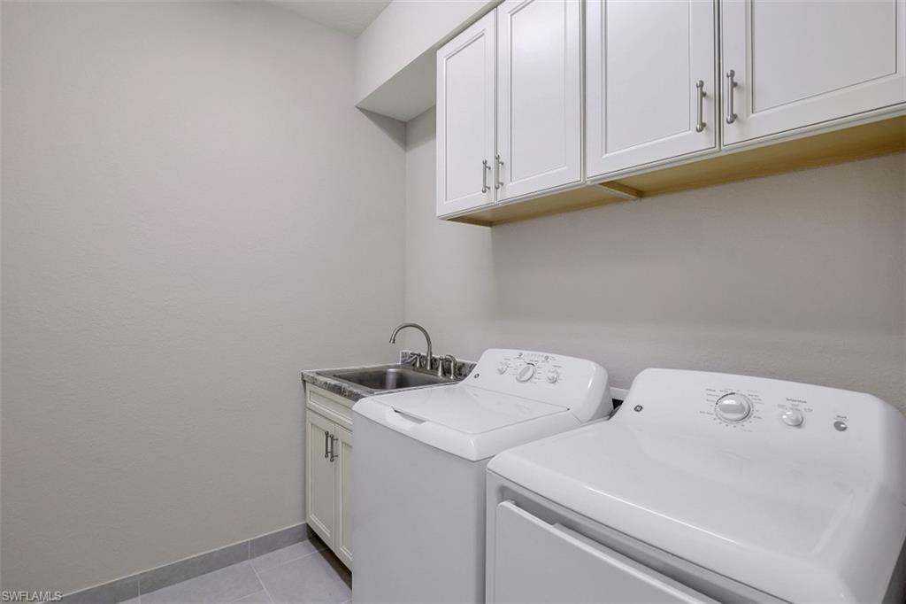4334 Aurora Street Naples, FL 34119 - Photo 21 of 31 a utility room with dryer and washer