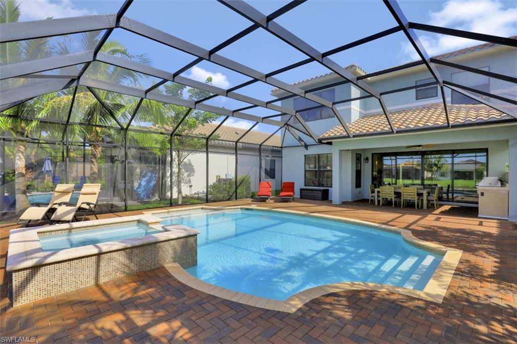 4334 Aurora Street Naples, FL 34119 - Photo 25 of 31 a view of a swimming pool with a patio