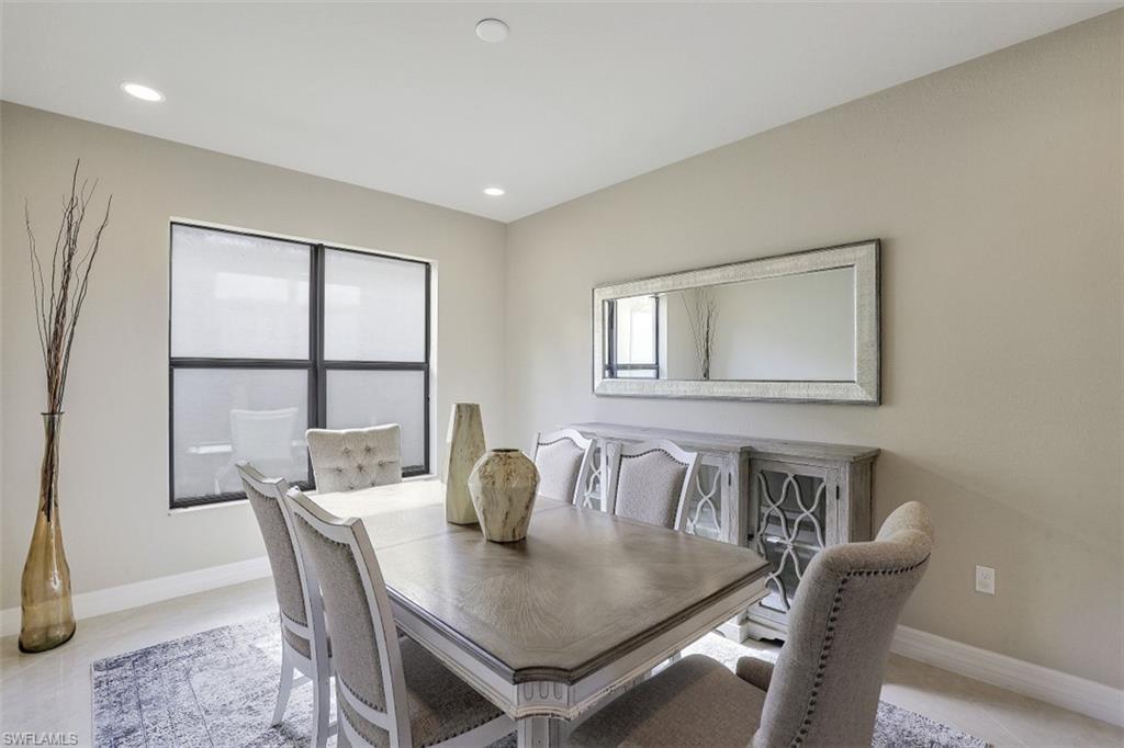 4334 Aurora Street Naples, FL 34119 - Photo 5 of 31 a view of a dining room with furniture and window