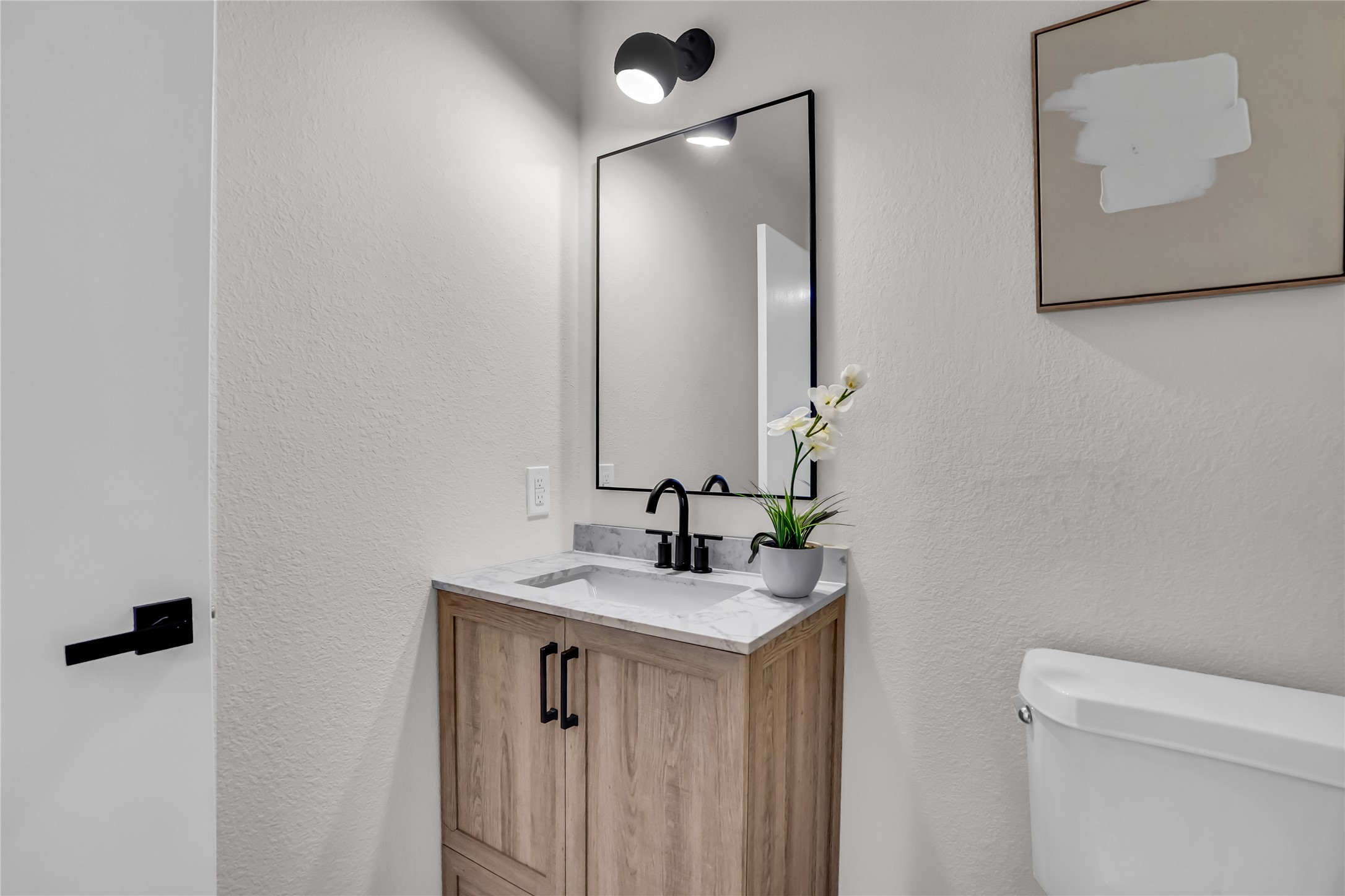 8921 Norwich Castle Austin, TX 78747 - Photo 14 of 33 a bathroom with a sink vanity and a mirror