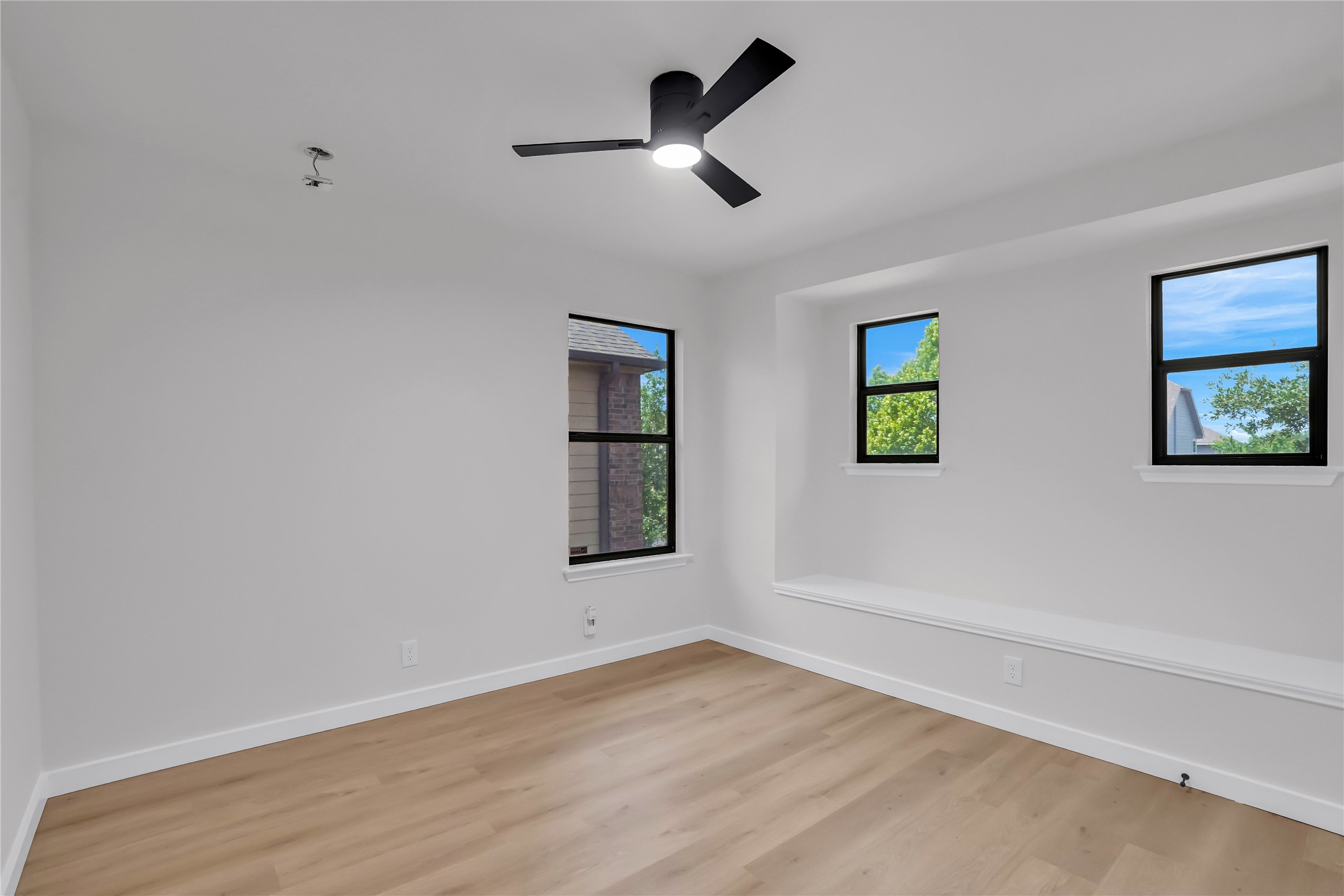 8921 Norwich Castle Austin, TX 78747 - Photo 22 of 33 a view of empty room with wooden floor and ceiling fan