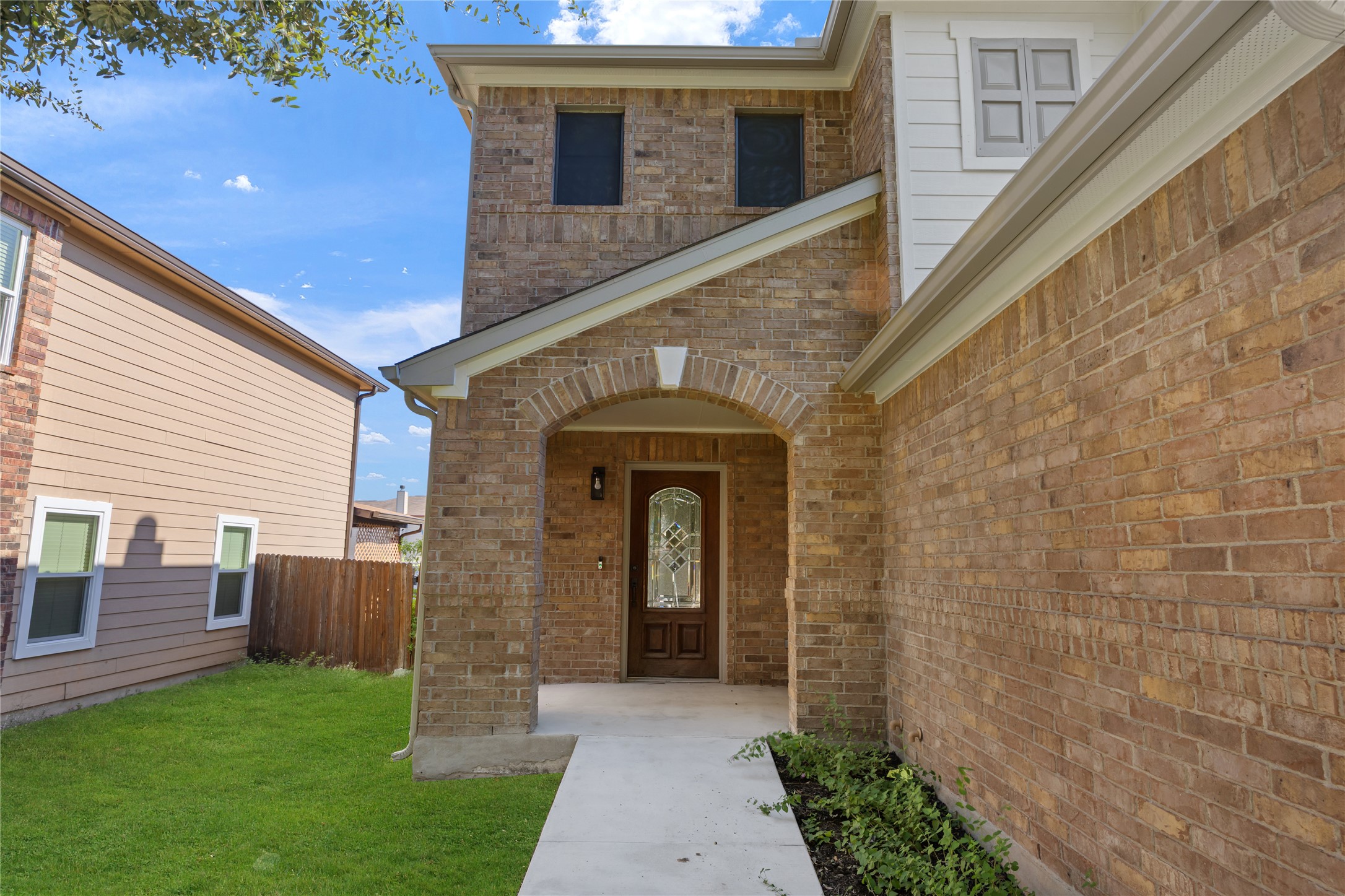 8921 Norwich Castle Austin, TX 78747 - Photo 3 of 33 a front view of a house with a garden