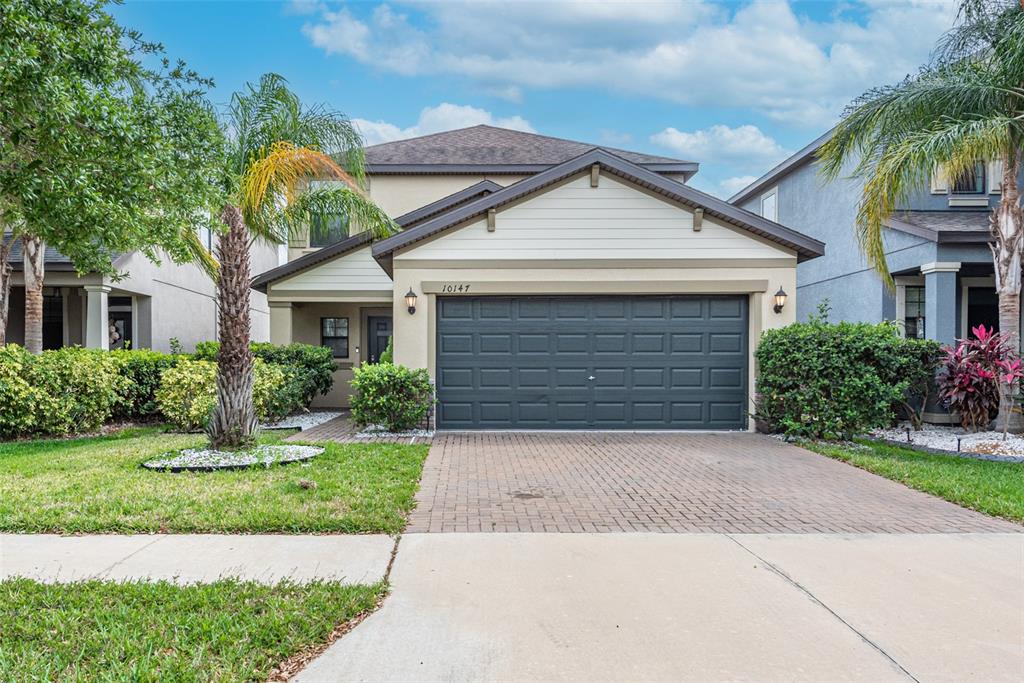 10147 Newminster Loop Ruskin, FL 33573 - Photo 1 of 1 a front view of a house with a garden