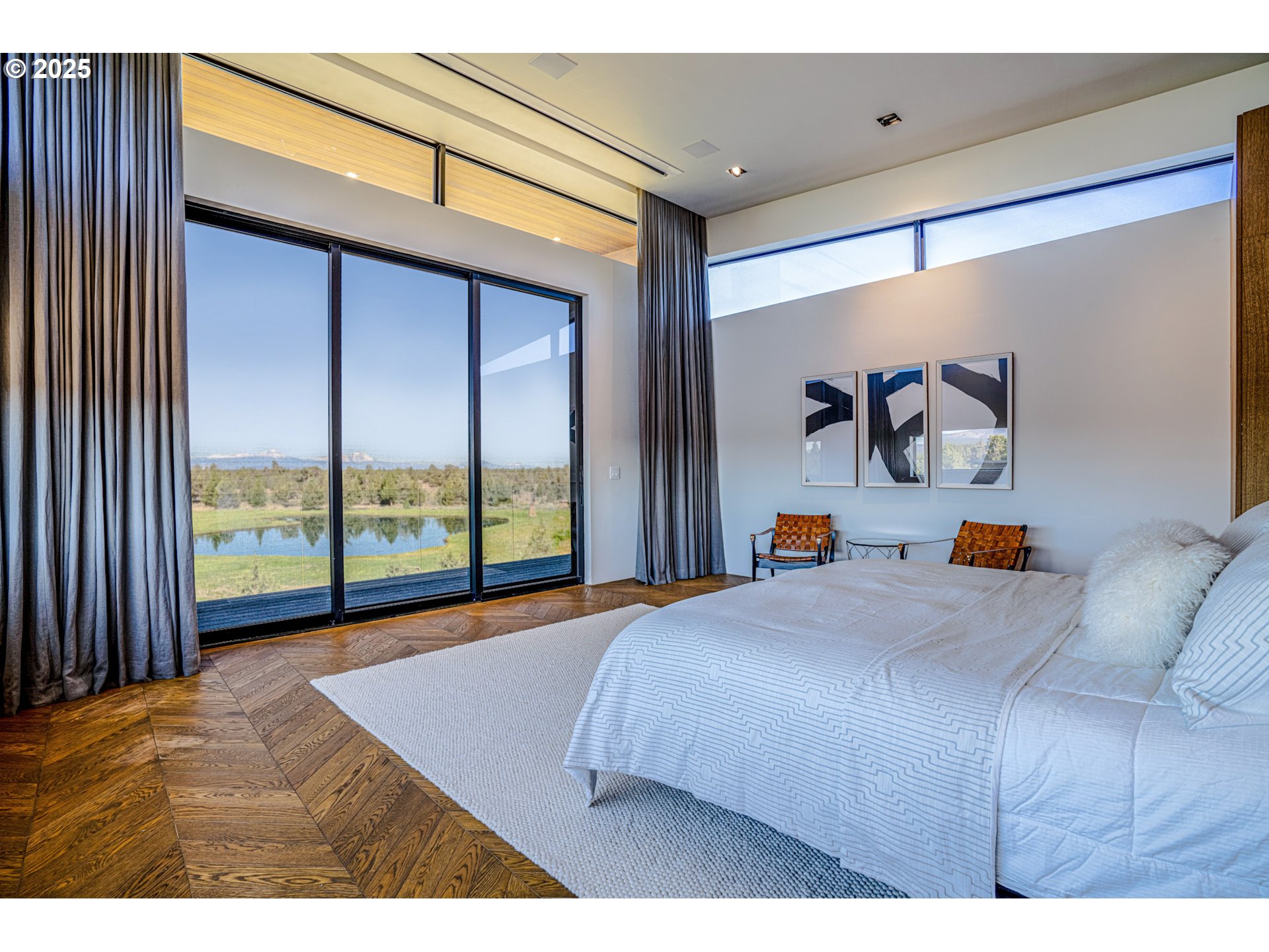 62265 Dodds Road Bend, OR 97701 - Photo 32 of 47 a bedroom with a large bed and a large window