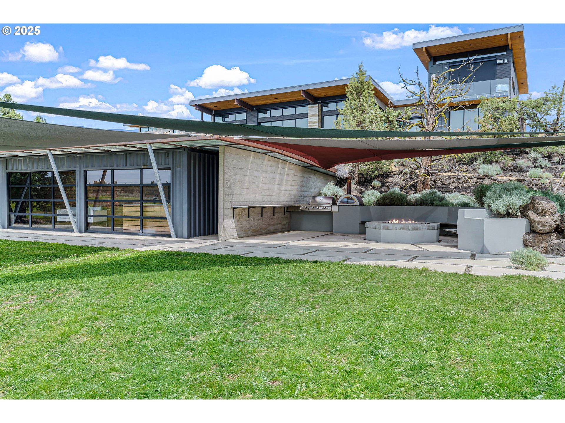 62265 Dodds Road Bend, OR 97701 - Photo 44 of 47 a view of a house with a backyard and a patio
