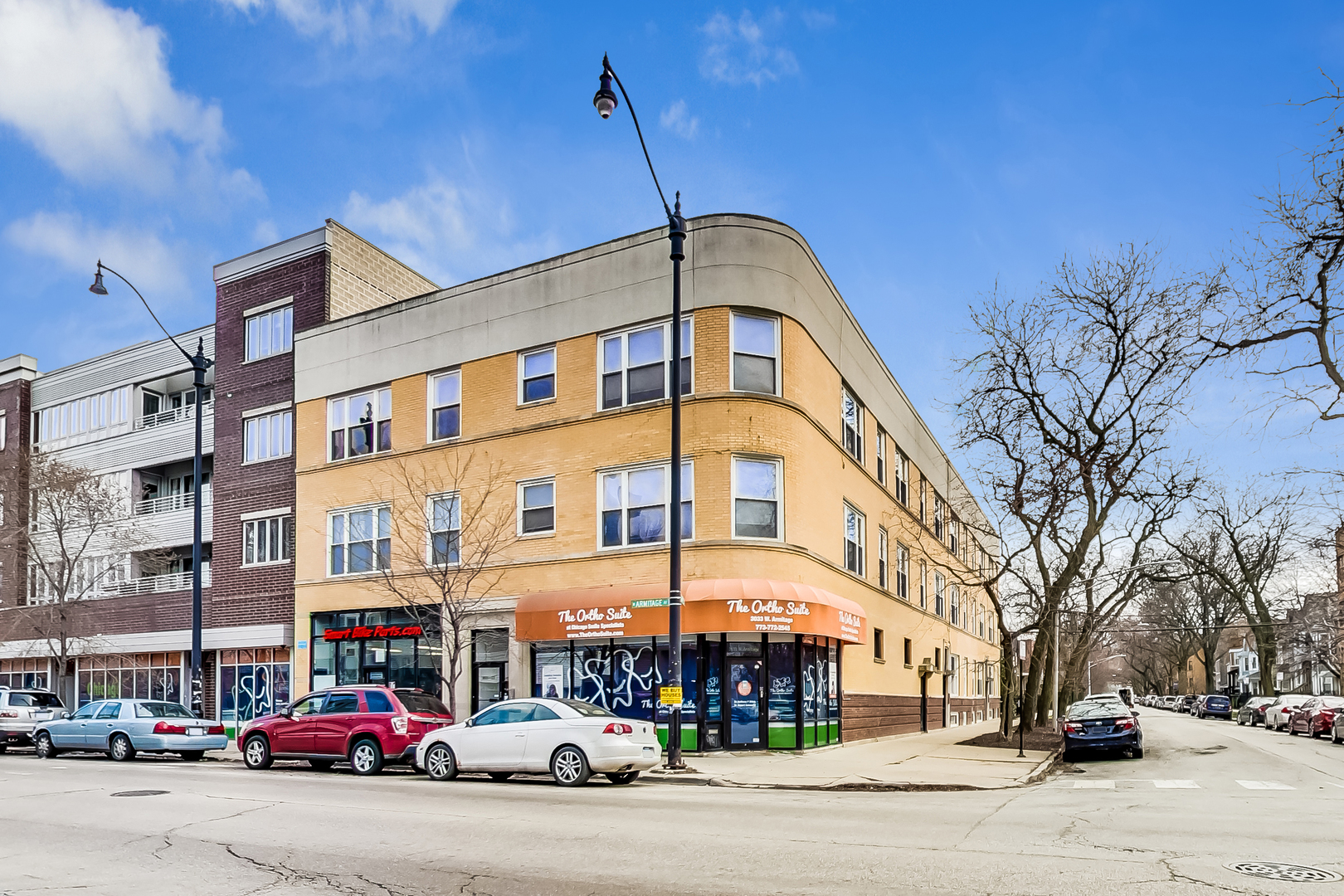 a city street lined with buildings and cars