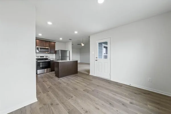 a kitchen with stainless steel appliances granite countertop a refrigerator and a microwave