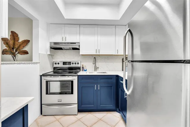 a kitchen with stainless steel appliances a stove a refrigerator and cabinets