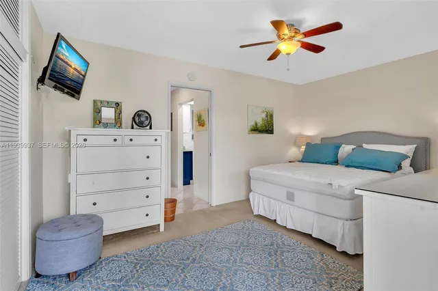 a bedroom with a bed and a television