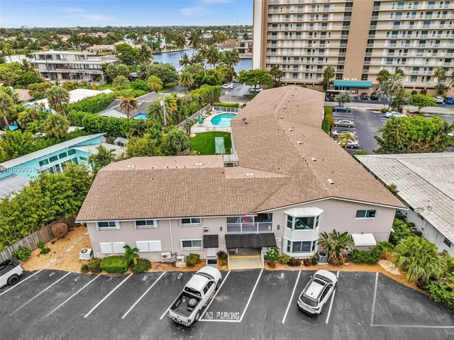 an aerial view of a house with sitting space and a patio