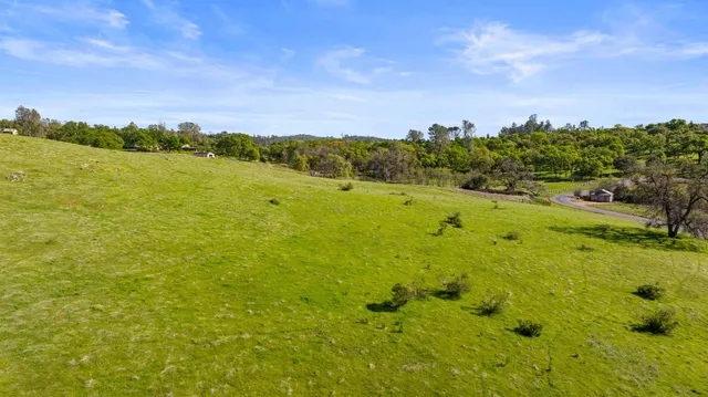 a view of a swimming pool with an outdoor seating and a yard