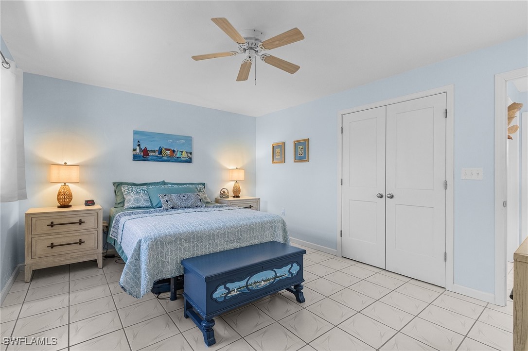 3201-3203 Stabile Road St. James City, FL 33956 - Photo 11 of 34 a bedroom with a bed and a chandelier