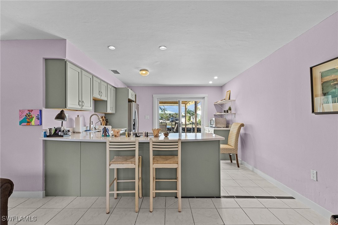 3201-3203 Stabile Road St. James City, FL 33956 - Photo 19 of 34 a room with stainless steel appliances a table and chairs in it