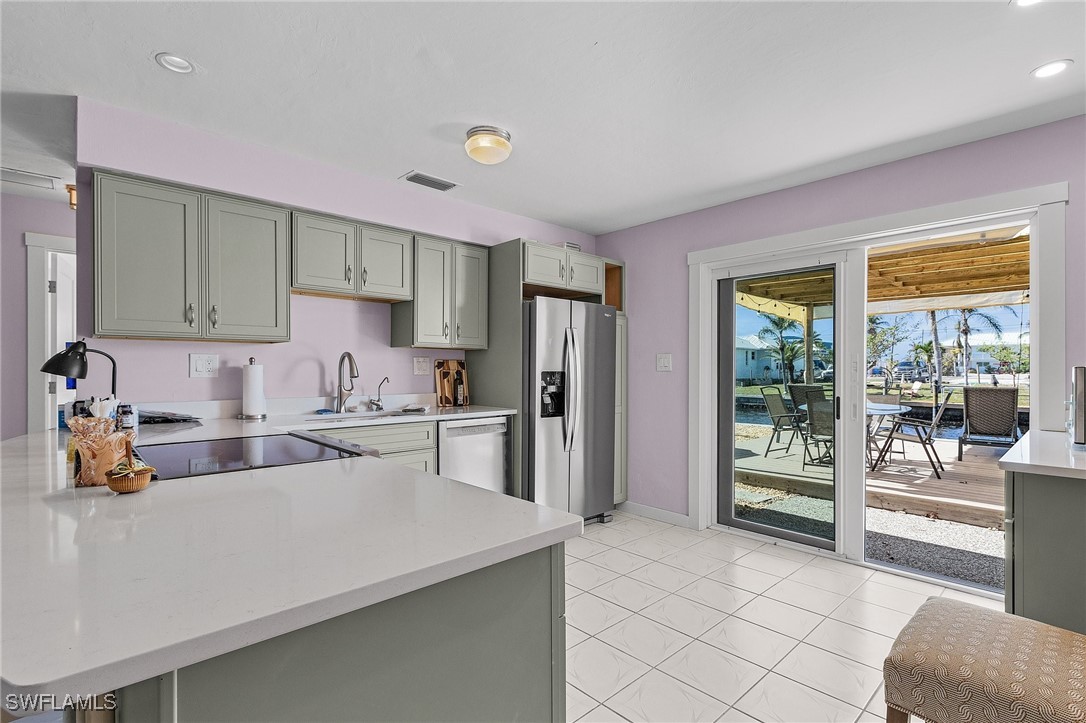 3201-3203 Stabile Road St. James City, FL 33956 - Photo 20 of 34 a kitchen with a stove a refrigerator and more cabinets