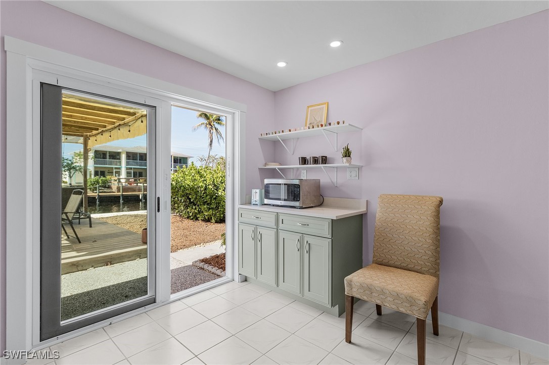 3201-3203 Stabile Road St. James City, FL 33956 - Photo 22 of 34 a room that has a chair and piano in it