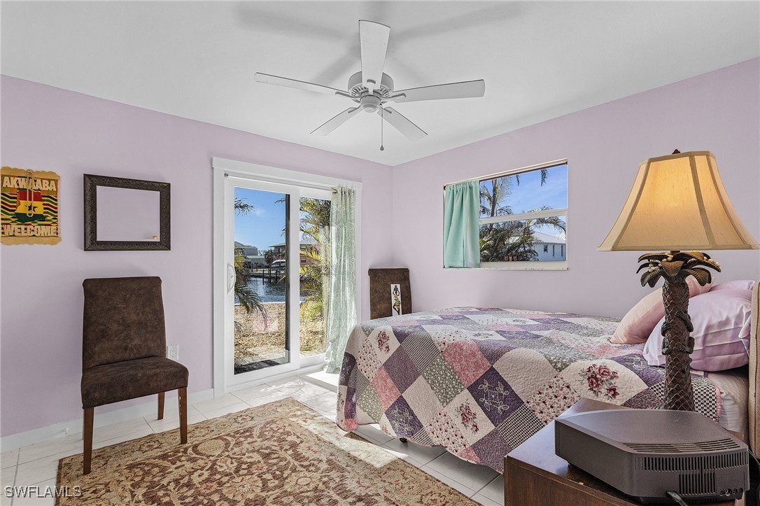 3201-3203 Stabile Road St. James City, FL 33956 - Photo 26 of 34 a bedroom with a bed and a chair