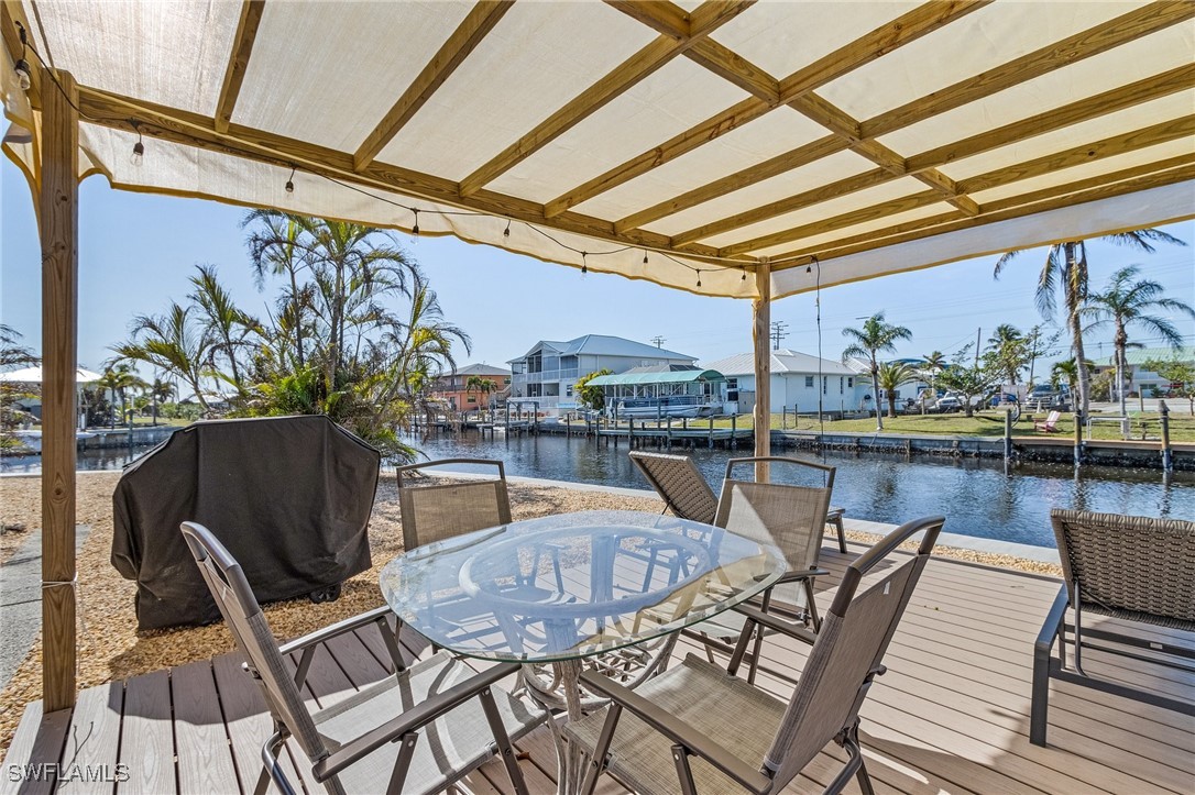 3201-3203 Stabile Road St. James City, FL 33956 - Photo 29 of 34 a view of a chairs and table in a patio