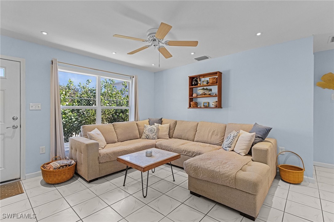 3201-3203 Stabile Road St. James City, FL 33956 - Photo 3 of 34 a living room with furniture and a window
