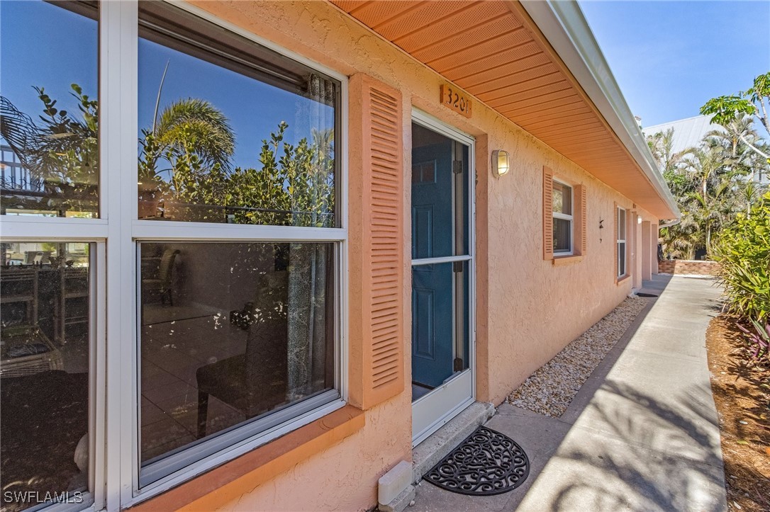 3201-3203 Stabile Road St. James City, FL 33956 - Photo 32 of 34 a front view of a house with garden