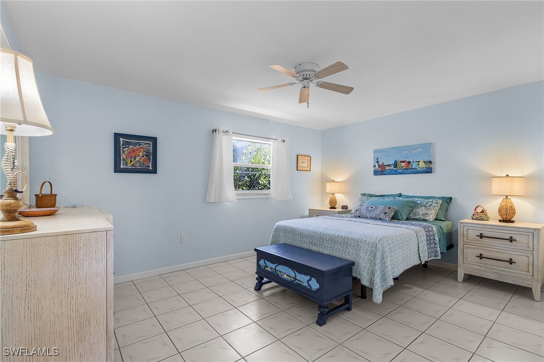 3201-3203 Stabile Road St. James City, FL 33956 - Photo 10 of 34 a bedroom with a bed and a window
