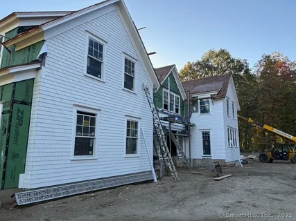 a view of a house with a yard and garage