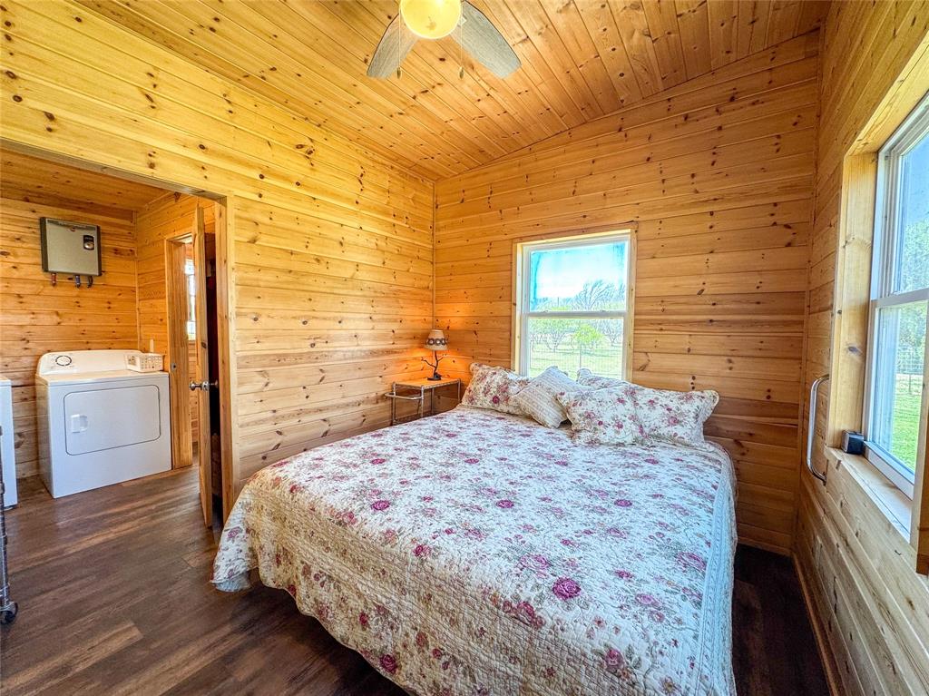 1209 Taylor Avenue Rule, TX 79547 - Photo 12 of 40 a bedroom with a bed and wooden floor