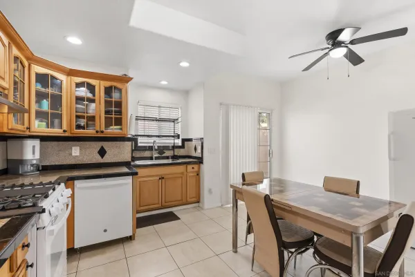 a kitchen with a stove a sink cabinets and wooden floor