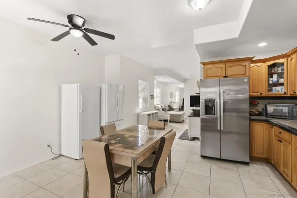 a kitchen with stainless steel appliances kitchen island granite countertop a refrigerator a stove a microwave oven with white cabinets and granite countertops