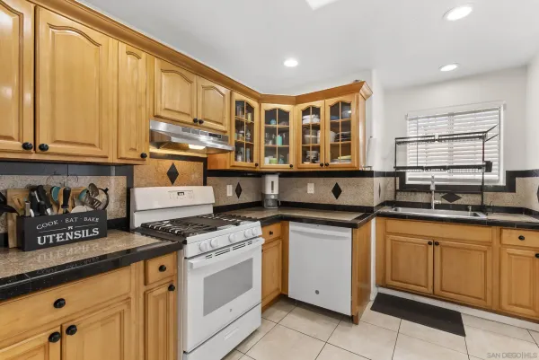 a kitchen with stainless steel appliances granite countertop a sink and cabinets