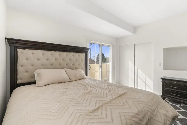 a bedroom with a bed and a dresser
