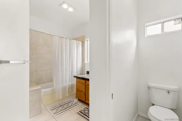 a bathroom with a shower and a toilet