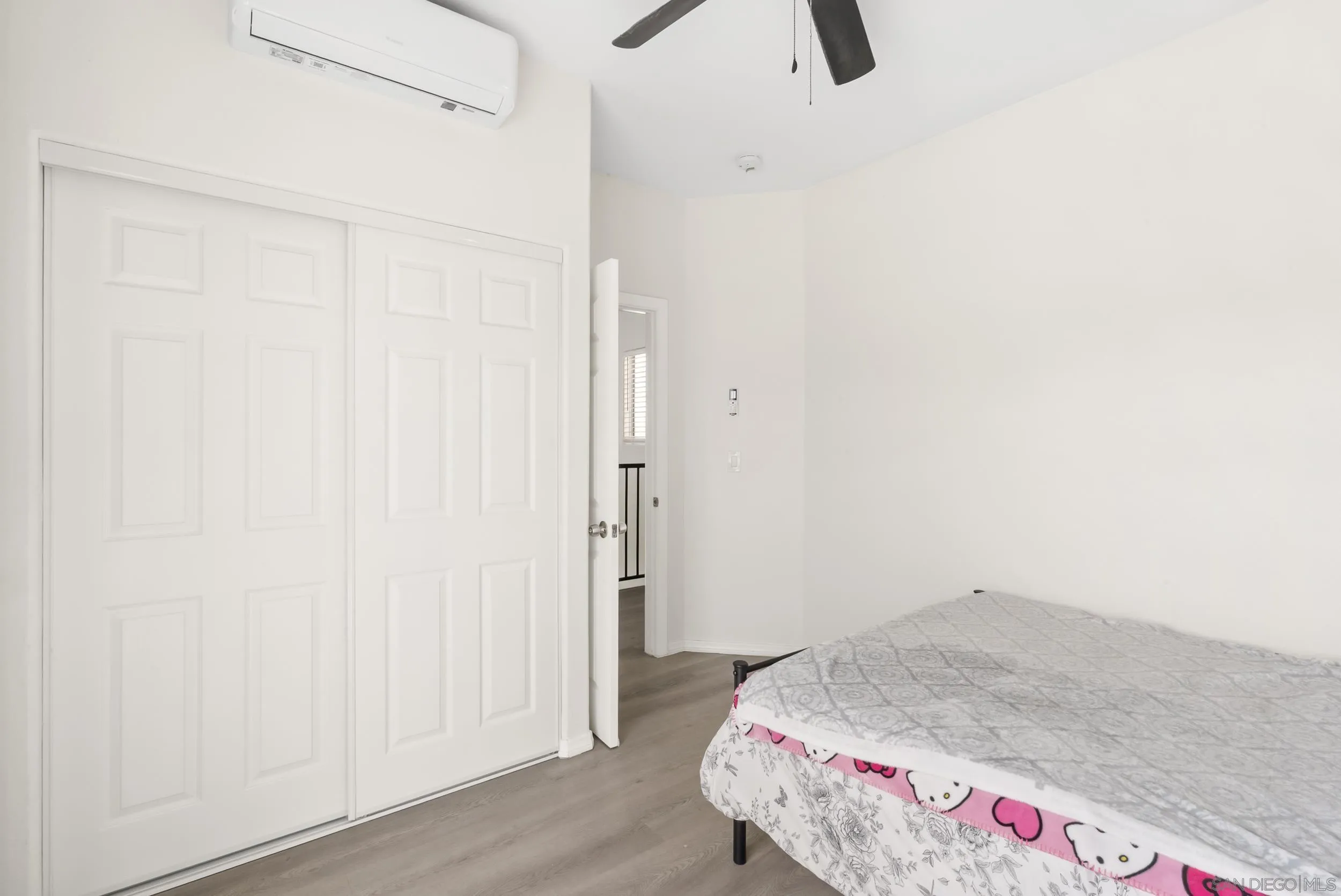 3746 Harding Avenue San Diego, CA 92113 - Photo 28 of 35 a bedroom with a bed and wooden floor