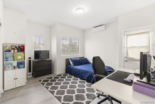 a bedroom with furniture and a window