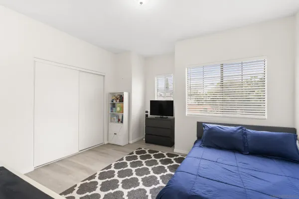 a bedroom with a bed and a dresser