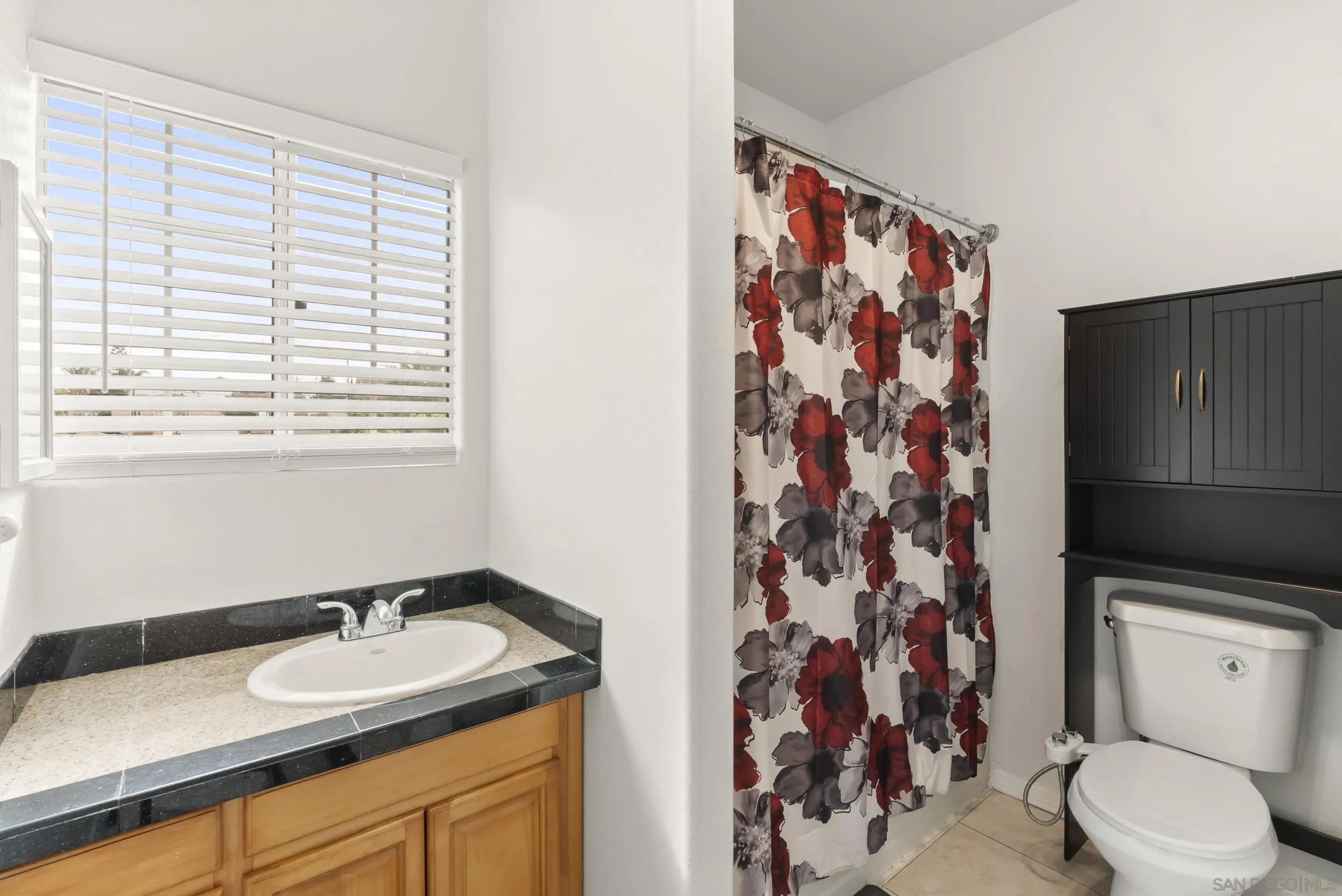 3746 Harding Avenue San Diego, CA 92113 - Photo 33 of 35 a bathroom with a granite countertop sink toilet and shower