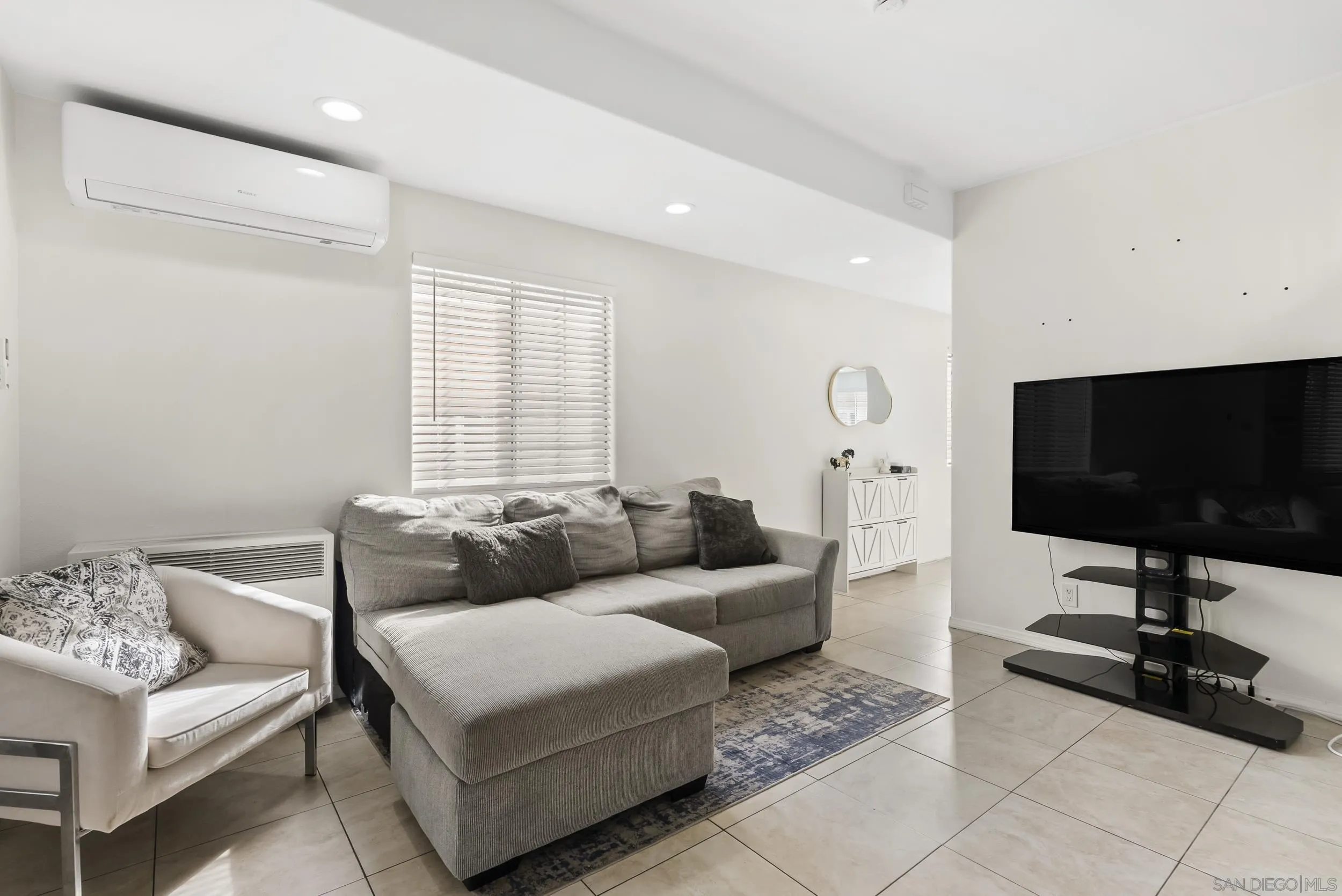 3746 Harding Avenue San Diego, CA 92113 - Photo 10 of 35 a living room with furniture and a flat screen tv