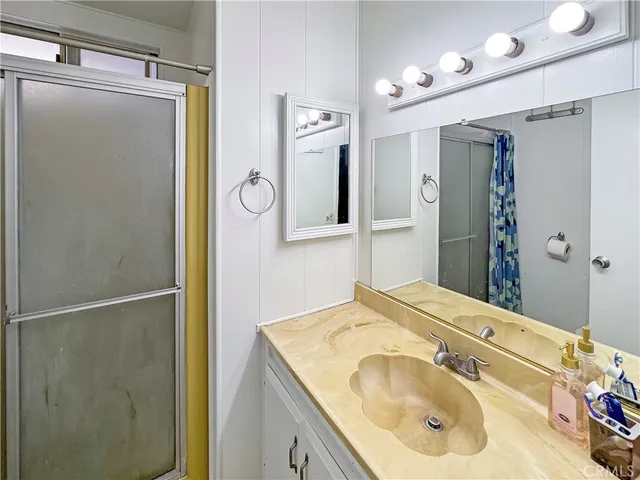 a bathroom with a sink vanity and a mirror