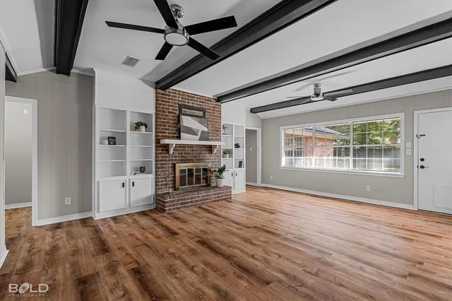 wooden floor in an empty room with a fireplace