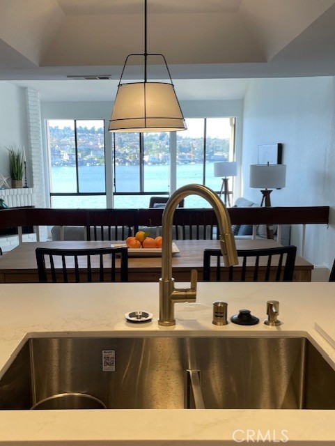 27793 Rota, Unit 14 Mission Viejo, CA 92692 - Photo 11 of 18 a living room with stainless steel appliances kitchen island a table chairs and a large window